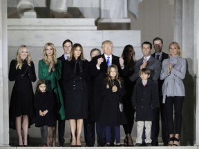 FILE - In this Jan. 19, 2017, file photo, then-President-elect Donald Trump and his wife Melania Trump and family wave at the conclusion of the pre-Inaugural "Make America Great Again! Welcome Celebration" at the Lincoln Memorial in Washington. Four years ago, well before the furor over allegations Moscow engaged in cybermeddling to help get Donald Trump elected, at least 195 web addresses belonging to Trump, his family or his business empire were hijacked by hackers who may have been operating out of Russia, The Associated Press has learned. The Trump Organization denied the domain names were ever compromised. But it was not until this week _ after the Trump camp was asked about it by the AP _ that the last of the tampered-with addresses were repaired. (AP Photo/David J. Phillip. File)