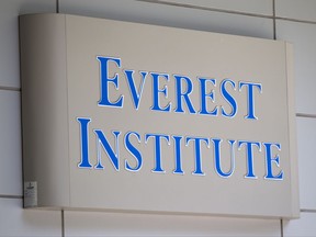FILE - In this July 8, 2014 file photo, an Everest Institute sign is seen in a office building in Silver Spring, Md. Students who attended for-profit colleges filed more than 98 percent of the requests for student loan forgiveness alleging fraud by their schools, according to an analysis of Education Department data published Thursday, Nov. 9. (AP Photo/Jose Luis Magana, File)