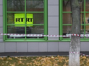 FILE - In this file photo taken dated Friday, Oct. 27, 2017, Russian state-owned television station RT logo is seen at the window of the company's office in Moscow, Russia. Russian state-funded TV channel RT has registered with the U.S. Justice Department as a foreign agent after pressure from the U.S. government. (AP Photo/Pavel Golovkin, FILE)