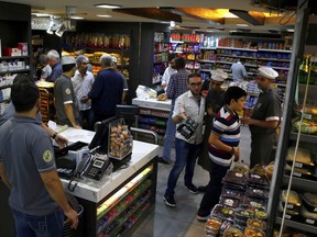 In this Nov. 10, 2017 photo, shoppers select products displayed on the shelves inside a supermarket in Beirut, Lebanon. Just when things were starting to look up for Lebanon, a new political crisis threatens to send the country crashing down again. Prime Minister Saad Hariri's shock resignation could unravel the first steps in years toward injecting some cash and confidence in Lebanon's anemic economy. (AP Photo/Bilal Hussein)