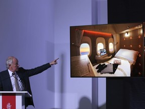 Emirates Airline President Tim Clark points out the image of new, state-of-the-art, first class private suites, during a press conference at the opening day of the Dubai Air Show, United Arab Emirates, Sunday, Nov. 12, 2017. In an industry first, passenger suites in the middle aisle without windows will be fitted with "virtual windows" relaying the sky outside via fiber optic cameras on the plane. (AP Photo/Kamran Jebreili)
