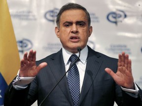 FILE - In this Aug. 23, 2017 file photo, Venezuela's Chief Prosecutor Tarek William Saab speaks during a news conference, in Caracas, Venezuela.  Venezuelan authorities detained the acting president of Citgo, the state-owned oil company's U.S. subsidiary, and five other executives for their alleged involvement in a corruption scheme, Saab said Tuesday, Nov. 21, 2017. (AP Photo/Ariana Cubillos, File)