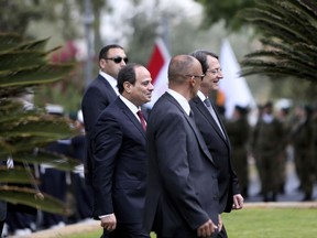 Egypt's President Abdel-Fattah el-Sissi, second from left, and Cyprus' President Nicos Anastasiades, right, walk to the steps of the Presidential Palace after reviewing a guard of honor following the Egyptian president's arrival to the Cypriot capital Nicosia for an official visit on Monday, Nov. 20, 2017. El-Sissi's visit aims to forge closer ties with Egypt's neighbor and comes a day ahead of the three-way meeting that will include the Greek prime minister. (AP Photo/Petros Karadjias)