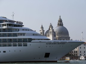 FILE - In this Sept. 27, 2014 file photo a cruise ship transits in the Giudecca canal in front of St. Mark's Square, in Venice, Italy. The Italian government and Venice officials on Wednesday Nov. 8, 2017 reached an agreement on a plan to block giant cruise ships from steaming past the lagoon city's iconic St. Mark's Square and instead re-route them to a nearby industrial port. (AP Photo/Andrew Medichini)