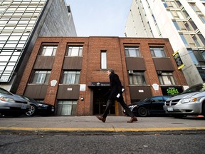 A man walks past a historic building site in Toronto.