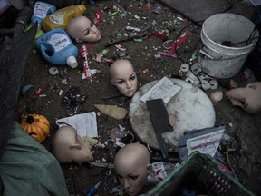 Plastic mannequin heads and other items lay on the ground before being recycled in the Dong Xiao Kou village in Beijing, China.