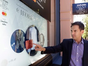 Steve Birnhak, CEO of Inwindow Outdoor, demonstrates his company's interactive screen in a New York storefront. Birnhak's company found opportunity in the vacant retail storefronts during the Great Recession.
