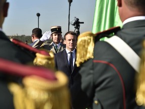 French President Emmanuel Macron reviews the troops as he arrives in Algiers, Wednesday, Dec.6, 2017. Macron is traveling to Algeria for a one-day working visit aimed at boosting the security and economic cooperation between the two countries.