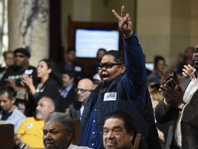 Donnie Anderson, co-founder and chairman of the California Minority Alliance, reacts after the Los Angeles City Council voted unanimously to approve new regulations for the marijuana industry on Wednesday, Dec. 6, 2017, in Los Angeles.
