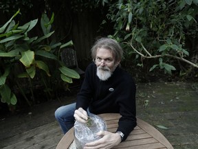 In this Dec. 22, 2017 photo, Dale Gieringer of NORML (National Organization for the Reform of Marijuana Laws) poses for photos at his house in Berkeley, Calif.. Californians may awake on New Year's Day to a familiar scent in greater-than-normal concentrations. A whiff of marijuana will likely be in the air as the nation's cannabis king lights up to celebrate the first legal retail sales of pot in the state.