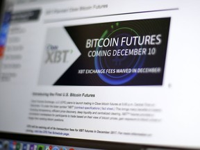 This Friday, Dec. 8, 2017, photo shows the Chicago Board Options Exchange website announcing that bitcoin futures will start trading on the CBOE on Sunday evening, Dec. 10. Bitcoin futures will start trading a week later on the Chicago Mercantile Exchange.