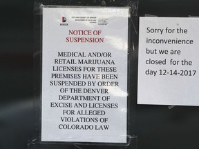 Closed signs are displayed on the front door to a marijuana dispensary along South Federal Boulevard Thursday, Dec. 14, 2017, in south Denver. Twenty-six legal marijuana businesses were closed by Denver officials Thursday amid a police investigation expected to lead to criminal charges.