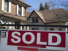 A sold sign is shown in front of west-end Toronto homes Sunday, April 9, 2017.