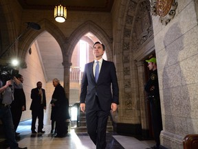 Finance Minister Bill Morneau arrives to talk to media on tax changes for small businesses in Ottawa on December 13, 2017. A new report from the federal Finance Department says better-than-expected economic growth in 2017 shaved several years of projected deficits from Canada's long-term financial future -- though many more years remain. The report predicts that barring any policy changes, the federal government could be on track for annual shortfalls until 2045-46, compared to projections last year that deficits would run to 2050-51.