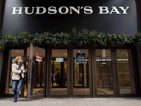 A women leaves the Hudson Bay Company store in Toronto on November 1, 2017. Hudson's Bay Co. filed a request Monday to the Competition Tribunal asking that it be given three months to produce tens of thousands of documents in a case of alleged deceptive pricing practices. The request is related to accusations by the Commissioner of Competition that HBC is possibly withholding documents related to its pricing practices of mattress and box spring sets, as well as other products from February 2015 until now.