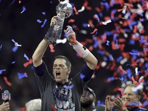 New England Patriots' Tom Brady raises the Vince Lombardi Trophy after defeating the Atlanta Falcons in overtime at the NFL Super Bowl 51 football game Sunday, Feb. 5, 2017, in Houston. The Federal Court of Appeal has dismissed Bell Canada and the NFL's appeal over a CRTC decision to ban substituting American ads with Canadian ones during the Super Bowl.