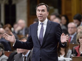 Minister of Finance Bill Morneau responds to a question during Question Period in the House of Commons Wednesday, November 29, 2017 in Ottawa. Bill Morneau is staying put as finance minister, but he admits he's closing out his tumultuous year with some regrets.THE CANADIAN PRESS/Adrian Wyld