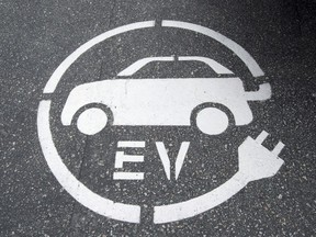 A electric vehicle charging sign is pictured in Squamish, B.C., on June, 1, 2016. Canadians will purchase a record nearly 20,000 electric vehicles this year but growing sales of cars with longer ranges is prompting a change of thinking about fast chargers, says the head of the country's largest charging network.