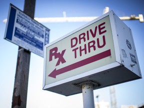 A sign directs customers to the pharmacy drive thru of a CVS Health Corp. store in Chicago. CVS will buy Aetna Inc. for about $67.5 billion, creating a health-care giant that will have a hand in everything from insurance to the corner drugstore.