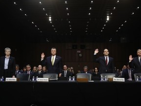 From left, Air Force Secretary Heather Wilson, Thomas Brandon, Acting Director of the Bureau of Alcohol, Tobacco, Firearms, and Explosives (ATF), Glenn Fine, Acting Inspector General, U.S. Department Of Defense, and Douglas Lindquist, Assistant Director Criminal Justice Information Services Division, FBI, Clarksburg, W.Va., are sworn in to testify during a Senate Judiciary Committee hearing on Capitol Hill in Washington, Wednesday, Dec. 6, 2017,