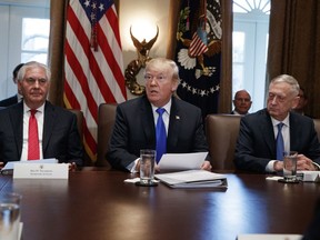 Secretary of State Rex Tillerson, left, and Secretary of Defense Jim Mattis, right, listen as President Donald Trump speaks during a cabinet meeting at the White House, Wednesday, Dec. 20, 2017, in Washington.