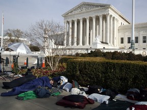 People sleep outside of the Supreme Court in order to save places in line for Dec. 5 arguments in 'Masterpiece Cakeshop v. Colorado Civil Rights Commission,' Monday, Dec. 4, 2017, outside of the Supreme Court in Washington.