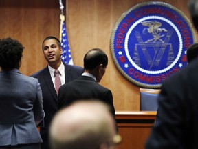 Federal Communications Commission (FCC) Chairman Ajit Pai, left, greets witnesses before a meeting where the FCC will vote on net neutrality, Thursday, Dec. 14, 2017, in Washington.