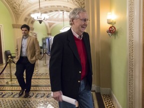 Ready to leave for the Christmas recess, Senate Majority Leader Mitch McConnell, R-Ky., walks to a news conference to discuss the GOP agenda for next year and and his accomplishments in the first year of the Trump Administration, on Capitol Hill in Washington, Friday, Dec. 22, 2017. Their tax bill triumph in the rear-view mirror, Republicans running Congress face a 2018 in which they'll need Democratic votes to get almost anything done.