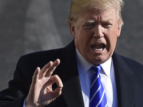 President Donald Trump talks with reporters as he departs from the South Lawn of the White House via Marine One in Washington, Saturday, Dec. 16, 2017, to spend the weekend at Camp David in Maryland.