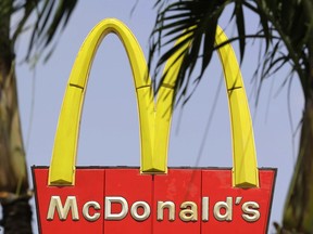 This Thursday, Aug. 3, 2017, photo shows a McDonald's sign at a restaurant in Hialeah, Fla. The Dollar Menu is making a McComeback. McDonald's says it is reviving the name of the once-popular value menu in January 2018, but this time the items will cost $1, $2 or $3.