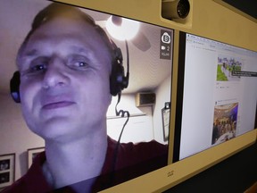 In this photo taken Monday, Dec. 18, 2017, engineer Matt King, who is blind, demonstrates facial recognition technology via a teleconference at Facebook headquarters in Menlo Park, Calif. Facebook is unveiling a new AI-powered feature just in time for alcohol-filled holiday parties: you can now see untagged pictures of your face on your friend's news feeds and ask the poster to remove them.