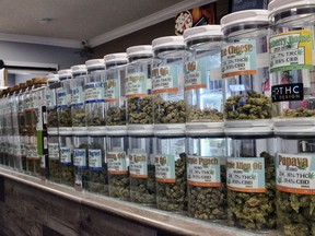FILE - This Friday, Nov. 3, 2017 photo shows jars of medical marijuana on display on the counter of Western Caregivers Medical marijuana dispensary in Los Angeles. On Wednesday, Dec. 6, 2017, the Los Angeles City Council is expected to consider a dense set of regulations that will dictate where pot can be grown and sold in the new market, along with how businesses will be licensed in L.A. (AP Photo/Richard Vogel, File)