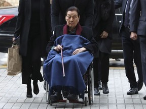 Lotte Group Founder Shin Kyuk-ho in a wheelchair, arrives at the Central District Court in Seoul, South Korea, Friday, Dec. 22, 2017. News reports say a Seoul court has convicted the 95-year-old founder of the Lotte Group and his son and group chairman on corruption charges.
