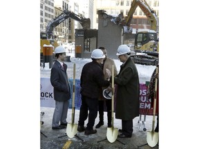Quicken Loans founder Dan Gilbert, center, meets with Joe Hudson, former CEO of the J.L. Hudson Company at the groundbreaking site of the city's new 800-foot-tall building, Thursday, Dec. 14, 2017, in Detroit. Bedrock Detroit real estate says the $900 million two-building project will include a 58-story residential tower and 12-floor building for retail and conference space. The tower will have an 800-foot-tall (244-meter) sky deck.