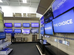 This Tuesday, May 23, 2017, photo shows televisions on display at a Best Buy in Cary, N.C. If you are shopping for a new flat-screen TV or dresser for the baby's room this holiday season, factoring in safety concerns can save you some trouble. Federal safety regulators recommend anchoring TVs and dressers to the wall to prevent them from tipping over, especially with small children around. Planning for that could influence which product you choose and where to put it in your home.