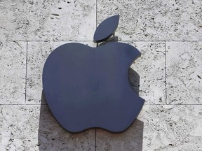 FILE - This Tuesday, Aug. 8, 2017, file photo shows the Apple logo at a store in Miami Beach, Fla. Apple is investing $390 million in Finisar, a company that makes the lasers used in facial recognition. The investment announced Wednesday, Dec. 13, is the latest from Apple's $1 billion Advanced Manufacturing Fund, dedicated to investments in U.S. manufacturers and creating jobs in the U.S.