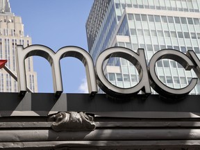 This Tuesday, May 2, 2017, photo shows Macy's corporate signage at its flagship store in Manhattan, in New York. Macy's is hiring an extra 7,000 seasonal associates this holiday season, saying traffic in its department stores nationwide has been high. (AP Photo/Bebeto Matthews)