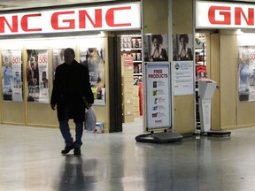 FILE - In this Tuesday, Feb. 3, 2015, file photo, a man leaves a GNC store in New York. GNC Holdings Inc. canceled a sale of senior notes and its plans to borrow more as it considers other options to raise funds. The Pittsburgh-based nutritional supplements company retained Goldman Sachs as its strategic adviser. The company did not specify its options, though a potential sale is usually part of a strategic alternatives search.