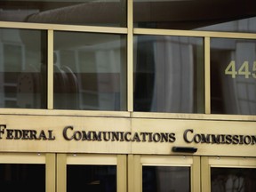 FILE - This June 19, 2015, file photo, shows the entrance to the Federal Communications Commission (FCC) building in Washington. "Net neutrality" regulations, designed to prevent internet service providers like Verizon, AT&T, Comcast and Charter from favoring some sites and apps over others, are on the chopping block. Federal Communications Commission Chairman Ajit Pai, a Republican, on Tuesday, Dec. 12, 2017, unveiled a plan to undo the Obama-era rules that have been in place since 2015.