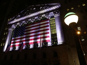 FILE - In this Friday, Feb. 17, 2017, file photo, an American flag hangs on the front of the New York Stock Exchange on an evening in New York. World stock markets mostly fell Tuesday, Dec. 5, 2017, as investors digested the possible impact of the U.S. tax legislation and the stalled Brexit negotiations.