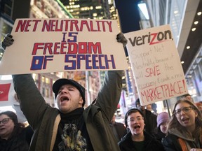 FILE - In this Thursday, Dec. 7, 2017, file photo, demonstrators rally in support of net neutrality outside a Verizon store in New York. The Federal Communications Commission is voting Thursday, Dec. 14 to undo Obama-era "net neutrality" rules that guaranteed equal access to the internet. The industry promises that the internet experience isn't going to change, but the issue has struck a nerve. Protests have erupted online and in the streets as everyday Americans worry that companies like Comcast, Verizon and AT&T will be able to control what they see and do online.