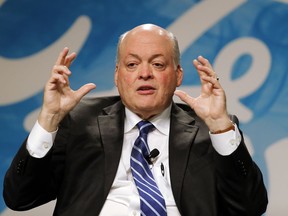 FILE - In this Monday, May 22, 2017, file photo, Jim Hackett speaks after being introduced as Ford Motor Company CEO, in Dearborn, Mich. Ford is collaborating with Chinese e-commerce giant Alibaba Group to further expand into the world's largest auto market. The carmaker signed a three-year agreement that will investigate ways to use technology for marketing, sales, cloud computing, and distribution strategies. It hopes to better incorporate digital technologies and platforms into its vehicles.
