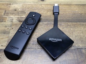 An Amazon Fire TV streaming device displayed with its remote.