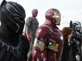 FILE - This file image provided by Disney shows, from left, Chadwick Boseman as Panther, Paul Bettany as Vision, Robert Downey Jr. as Iron Man, Scarlett Johansson as Natasha Romanoff, and Don Cheadle as War Machine in a scene from "Marvel's Captain America: Civil War." Disney's announcement Thursday, Dec. 14, 2017, that it's buying most of movie goliath Fox for $52.4 billion in stock brings these once disparate franchises together. The combined company will account for more than a third of theatrical revenues in the U.S. and Canada. (Disney Marvel via AP, File)