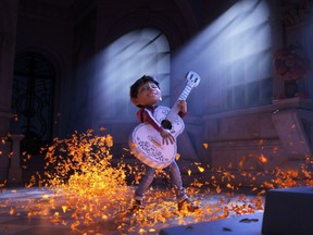 This image released by Disney-Pixar shows characters Miguel, voiced by Anthony Gonzalez in a scene from the animated film, "Coco."