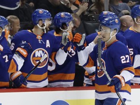 New York Islanders' Anders Lee (27) celebrates with teammates after scoring a goal during the first period of an NHL hockey game against the Detroit Red Wings, Tuesday, Dec. 19, 2017, in New York.