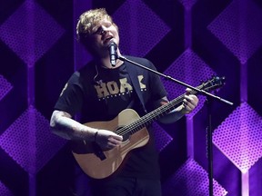 FILE - In this Dec. 1, 2017, file photo, Ed Sheeran performs at Jingle Ball at The Forum in Inglewood, Calif. The Grammys may have dissed Sheeran, but Spotify says he's the most streamed artist of the year. The streaming service announced Tuesday, Dec. 5, that Sheeran tops its 2017 list with 6.3 billion streams.