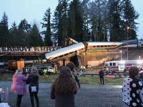 In this photo provided by Daniella Fenelon, first responders work at the scene of an Amtrak train that derailed in DuPont, south of Seattle on Monday, Dec. 18, 2017. The Amtrak train making the first-ever run along a faster new route hurtled off an overpass south of Seattle and spilled some of its cars onto the highway below, killing some people, injuring dozens and crushing a few vehicles, authorities said. Fenelon was a passenger of the train.