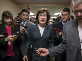 FILE- In this Nov. 30, 2017, file photo, with reporters looking for updates, Sen. Susan Collins, R-Maine, and other senators rush to the chamber to vote on amendments as the Republican leadership works to craft their sweeping tax bill in Washington. Collins said she is confident President Donald Trump and Senate Majority Leader Mitch McConnell will ensure passage of two bills aimed at shoring up the insurance markets, a demand she made before supporting the Republican tax overhaul.
