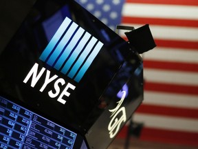 A logo for the New York Stock Exchange is displayed above the trading floor, Wednesday, Dec. 27, 2017. Wall Street delivered big gains and shattered stock market records in 2017 as a global economic rebound, strong company earnings growth and the GOP-led push to slash corporate taxes and enact other pro-business policies encouraged investors to keep buying stocks even as share prices climbed ever higher.